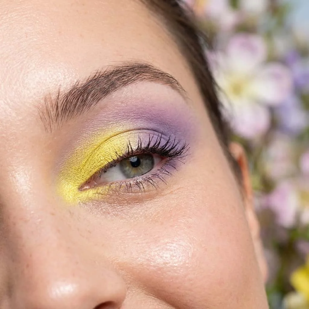 Lemon yellow eyeshadow blending into lilac purple on lid
